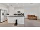 Modern kitchen with an island, stainless steel refrigerator and appliances adjacent to the living area at 2029 Crystal Bell St, Orlando, FL 32824