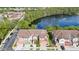 Aerial view of a charming townhome community surrounding a beautiful pond with a fountain at 2112 Rookery Ln, Sanford, FL 32773