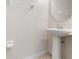 Powder room features a pedestal sink and tile flooring, offering a clean and functional space at 2112 Rookery Ln, Sanford, FL 32773