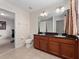 Bright bathroom with double sink vanity, granite counters, and tile floors at 2112 Rookery Ln, Sanford, FL 32773