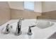 Close up of a luxurious bathtub with chrome fixtures and tiled backsplash, perfect for relaxation at 2112 Rookery Ln, Sanford, FL 32773