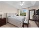 Comfortable main bedroom with tray ceiling, large window with view, and carpet flooring at 2112 Rookery Ln, Sanford, FL 32773