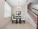 Cozy dining room features a glass table, two chairs, and a modern chandelier at 2112 Rookery Ln, Sanford, FL 32773