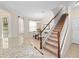 Inviting entryway featuring staircase, tile flooring, and a dining area with natural lighting at 2112 Rookery Ln, Sanford, FL 32773