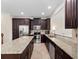 Well-equipped kitchen with stainless steel appliances, a central island, and dark wood cabinets at 2112 Rookery Ln, Sanford, FL 32773
