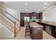 Spacious kitchen with granite countertops, stainless steel appliances, and dark wood cabinets near stairs at 2112 Rookery Ln, Sanford, FL 32773