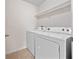 Laundry room with tile floor, washer, dryer, and wire shelf at 2112 Rookery Ln, Sanford, FL 32773