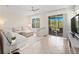 Bright living room with tiled floors, neutral decor, and sliding doors leading to the screened patio at 2112 Rookery Ln, Sanford, FL 32773