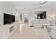 Open-concept living room with tile floors, a neutral palette, and a seamless transition to the dining area at 2112 Rookery Ln, Sanford, FL 32773