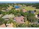 Aerial view of the house among trees near a golf course and lake at 2241 Lake Vilma Dr, Orlando, FL 32835