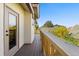 Exterior view of the private balcony featuring wood flooring and wood railings at 2241 Lake Vilma Dr, Orlando, FL 32835