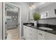 Bathroom featuring a double sink vanity with black granite countertops and modern lighting fixtures at 2241 Lake Vilma Dr, Orlando, FL 32835