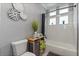 Well-lit bathroom featuring a bathtub and shower combo with stylish black and white decor at 2241 Lake Vilma Dr, Orlando, FL 32835