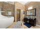 Contemporary bathroom featuring a soaking tub and vanity with glass vessel sink at 2241 Lake Vilma Dr, Orlando, FL 32835
