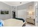 Cozy bedroom featuring a TV, white closet, and decorative art at 2241 Lake Vilma Dr, Orlando, FL 32835