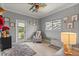 Bright bedroom with a fun ceiling fan, door to the exterior, and hardwood floors at 2241 Lake Vilma Dr, Orlando, FL 32835