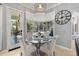 Bright breakfast nook with glass table, four chairs, and a view to the patio and backyard at 2241 Lake Vilma Dr, Orlando, FL 32835
