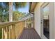 A lovely deck with wood railing leads to the pool and screened in porch area at 2241 Lake Vilma Dr, Orlando, FL 32835