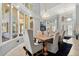 Bright dining area with elegant lighting, a large table, and floor to ceiling windows at 2241 Lake Vilma Dr, Orlando, FL 32835