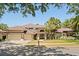 Charming home with a tile roof, mature palms, and a two-car garage at 2241 Lake Vilma Dr, Orlando, FL 32835
