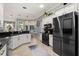 Modern kitchen with white cabinets, black countertops, stainless steel appliances and tiled floors at 2241 Lake Vilma Dr, Orlando, FL 32835