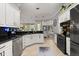 Well-lit kitchen featuring stainless steel appliances, breakfast nook, and view to backyard at 2241 Lake Vilma Dr, Orlando, FL 32835