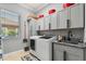 Convenient laundry room with washer, dryer, storage cabinets, and utility sink at 2241 Lake Vilma Dr, Orlando, FL 32835