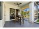 Covered patio area with ceiling fan and outdoor dining space at 2241 Lake Vilma Dr, Orlando, FL 32835