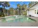 A large screened in pool area with jacuzzi and seating areas for relaxing at 2241 Lake Vilma Dr, Orlando, FL 32835