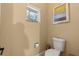 Small toilet room featuring a window and tan walls at 2241 Lake Vilma Dr, Orlando, FL 32835