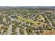 Expansive aerial view of the golf course community showcasing the serene lake and picturesque homes at 2302 Edmonton Ct, Clermont, FL 34711