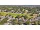 Aerial view showcasing a home nestled in a community with lush landscaping and a golf course at 2302 Edmonton Ct, Clermont, FL 34711