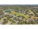 Breathtaking aerial view of the golf course community highlighting the pond and lush greenery at 2302 Edmonton Ct, Clermont, FL 34711