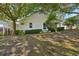 Lush backyard with mature trees and manicured landscaping provides a serene outdoor space at 2302 Edmonton Ct, Clermont, FL 34711