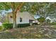 Expansive backyard featuring mature trees and well-maintained landscaping offers privacy and space at 2302 Edmonton Ct, Clermont, FL 34711