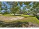 Picturesque view of the backyard with mature trees and green space extending into the distance at 2302 Edmonton Ct, Clermont, FL 34711