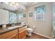 Comfortable bathroom featuring a wood vanity with granite countertop and a shower/bath combination at 2302 Edmonton Ct, Clermont, FL 34711