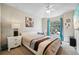 Cozy bedroom with carpet flooring, a queen size bed, study desk, and matching nightstand and lamp at 2302 Edmonton Ct, Clermont, FL 34711