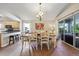 Bright dining area with access to the patio, adjacent to the kitchen with bar stool seating at 2302 Edmonton Ct, Clermont, FL 34711