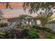 Inviting single-story home with lush landscaping, two-car garage, and picturesque sunset backdrop at 2302 Edmonton Ct, Clermont, FL 34711