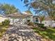 Attractive home featuring mature trees, a well-kept lawn, and a spacious driveway at 2302 Edmonton Ct, Clermont, FL 34711