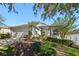 Beautiful home with a well-maintained lawn, mature landscaping, and a two-car garage at 2302 Edmonton Ct, Clermont, FL 34711