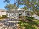 Charming single-story home with a two-car garage, well-manicured landscaping, and mature shade trees at 2302 Edmonton Ct, Clermont, FL 34711