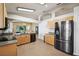 Open kitchen with stainless steel appliances, granite countertops, and seamless flow to dining and living areas at 2302 Edmonton Ct, Clermont, FL 34711