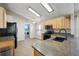 Bright kitchen featuring granite counters, modern appliances, and adjacent laundry area at 2302 Edmonton Ct, Clermont, FL 34711