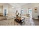 Bright living room featuring neutral colors, comfortable seating, and a stylish area rug at 2302 Edmonton Ct, Clermont, FL 34711