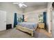 Bright main bedroom featuring vaulted ceilings, carpet flooring, and a king size bed with exterior views at 2302 Edmonton Ct, Clermont, FL 34711