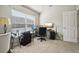 Home office features a bright window, computer desk with dual monitors, and neutral paint at 2302 Edmonton Ct, Clermont, FL 34711