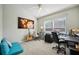 Bright home office features large world map wall art, two desks, and bright window at 2302 Edmonton Ct, Clermont, FL 34711