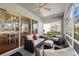 Inviting screened porch offers stylish seating with a ceiling fan for added comfort at 2302 Edmonton Ct, Clermont, FL 34711